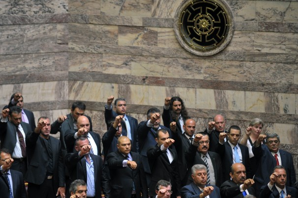 Golden Dawn members give a raised-fist salute as they are sworn into parliament. Louisa Gouliamaki / AFP via Getty Images