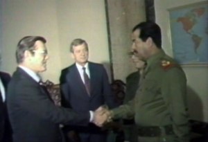 Donald Rumsfeld and Saddam Hussein exchange greetings